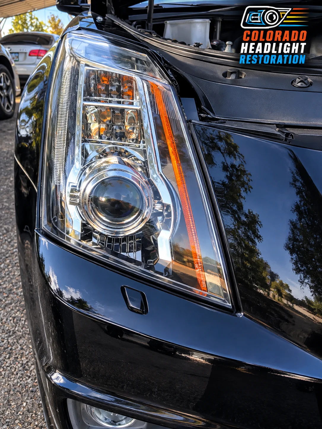 Black SUV headlight lens close-up after restoration