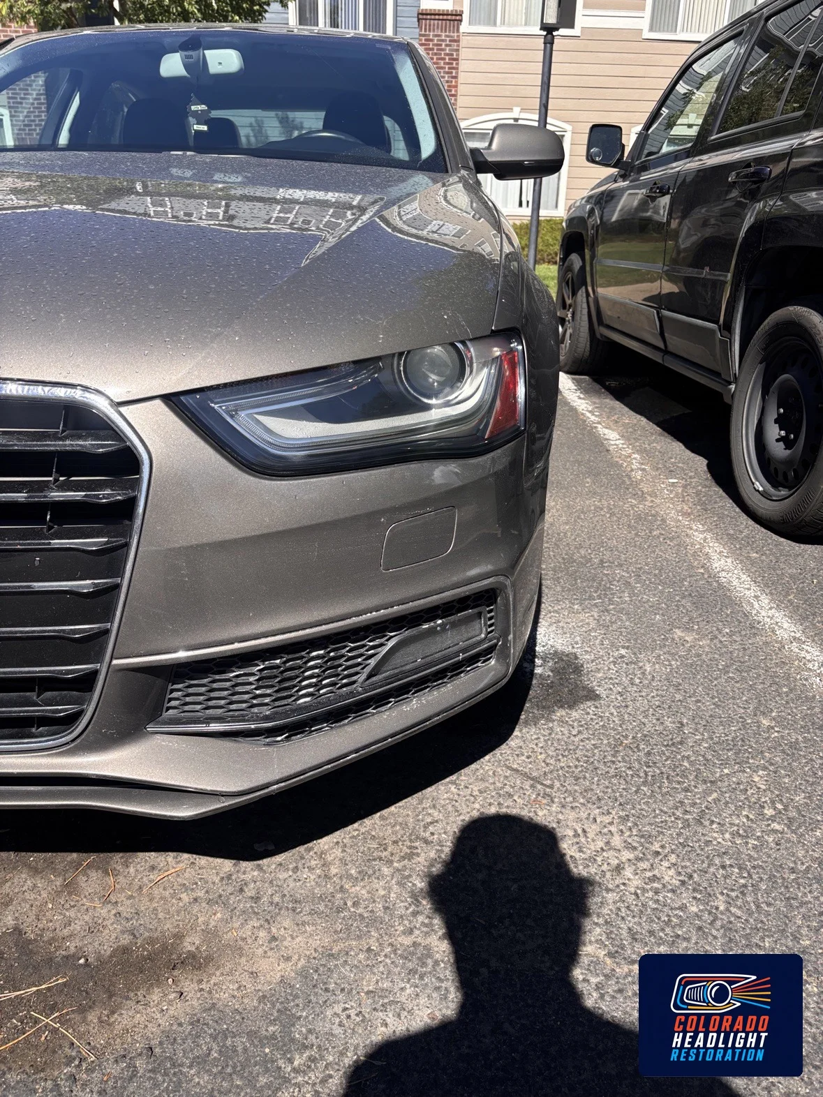 Gray sedan front view showing its headlights