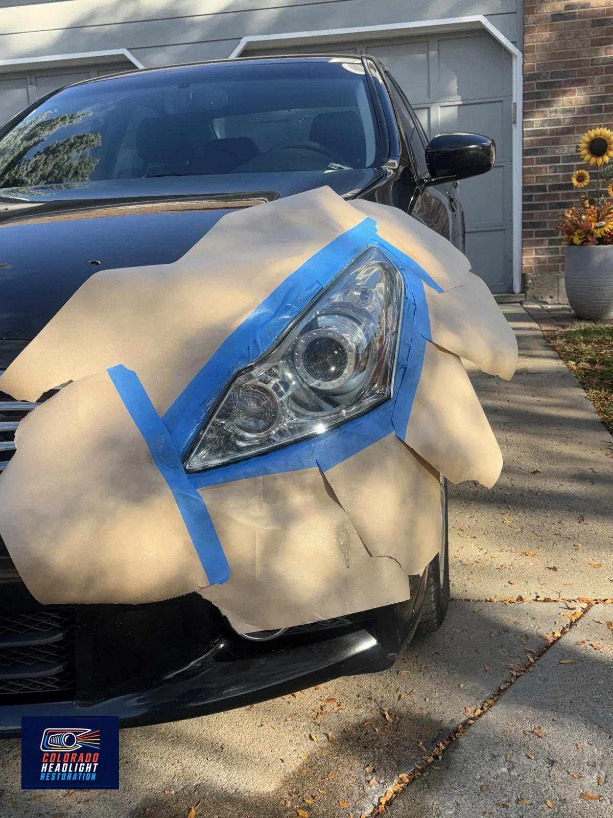 Infiniti headlight restoration — protective masking during the job