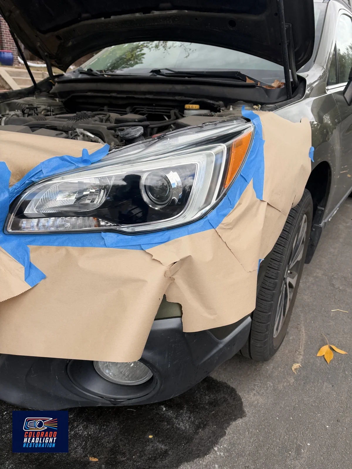 Subaru headlight restoration — protective masking during the job