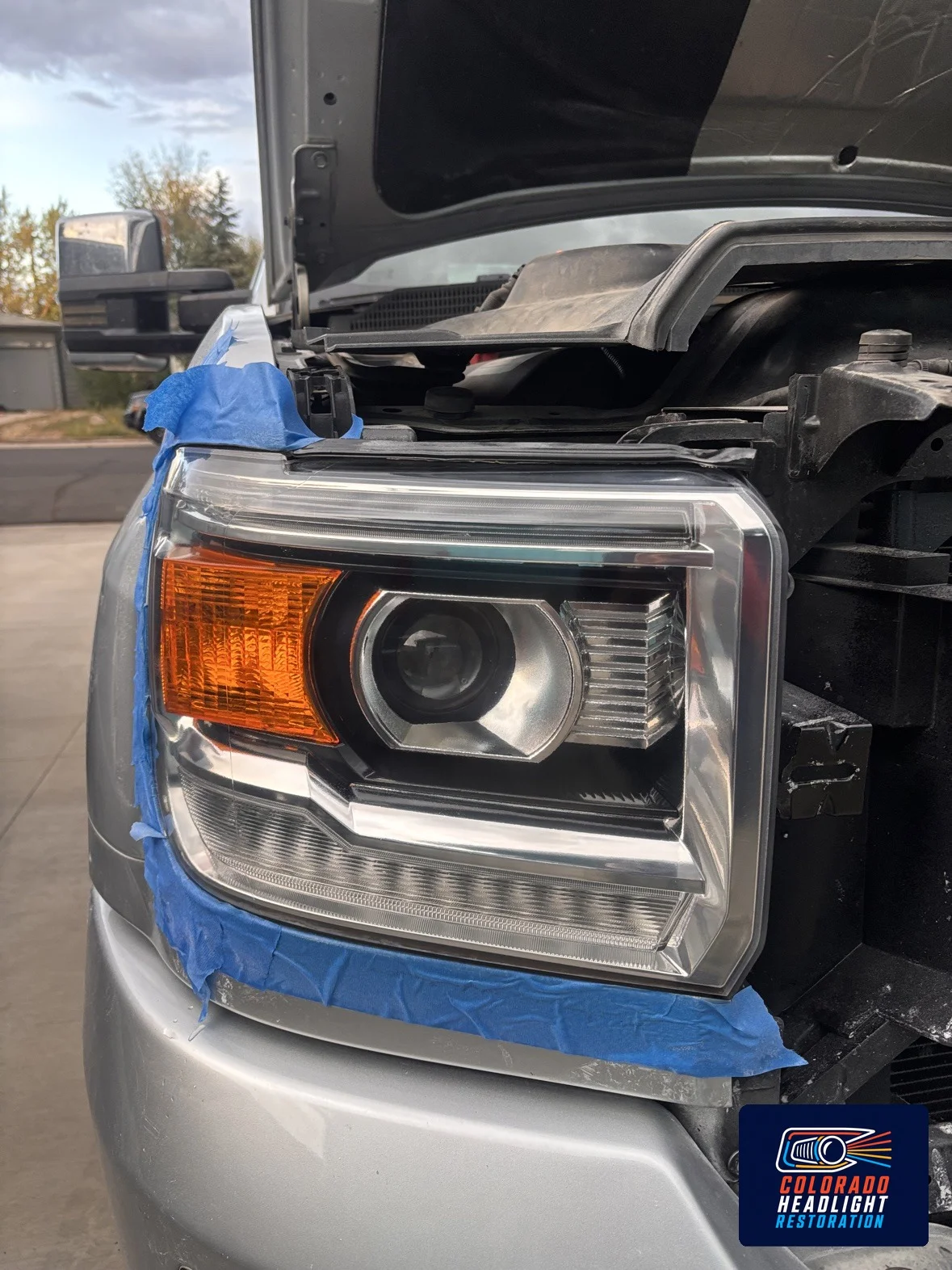 Pickup headlight lens during restoration with hood raised