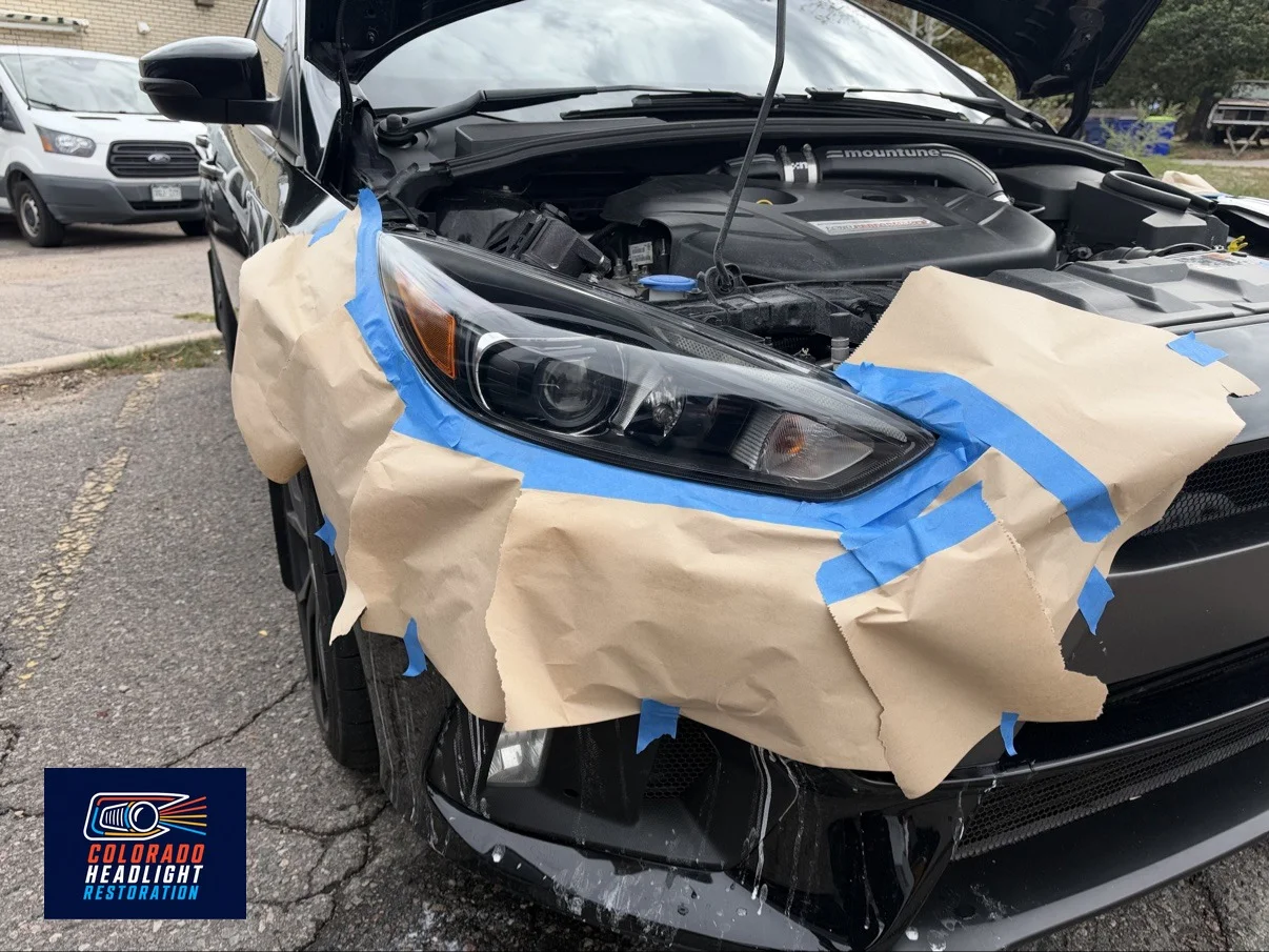 Ford Focus headlight restoration — protective masking during the job