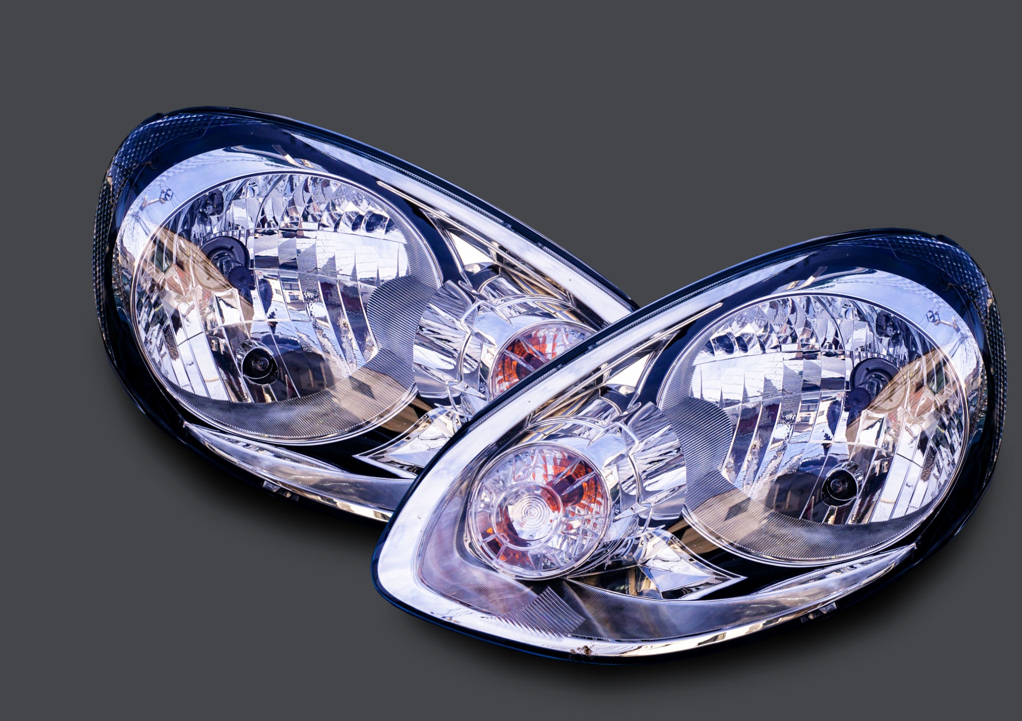 Pair of clear bright car headlights on vehicle front