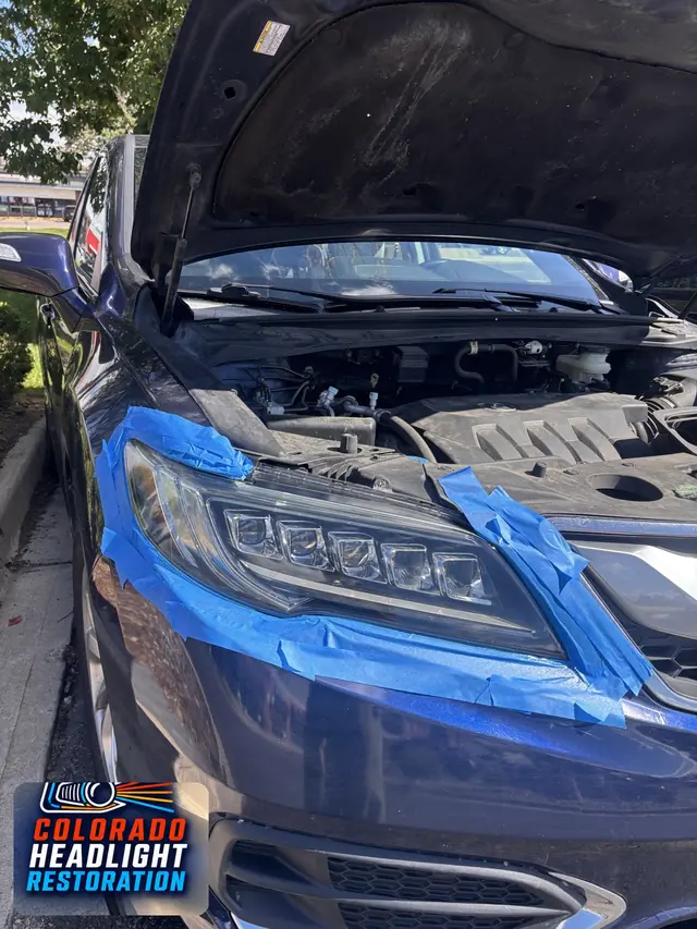 Blue SUV headlight with blue protective masking tape