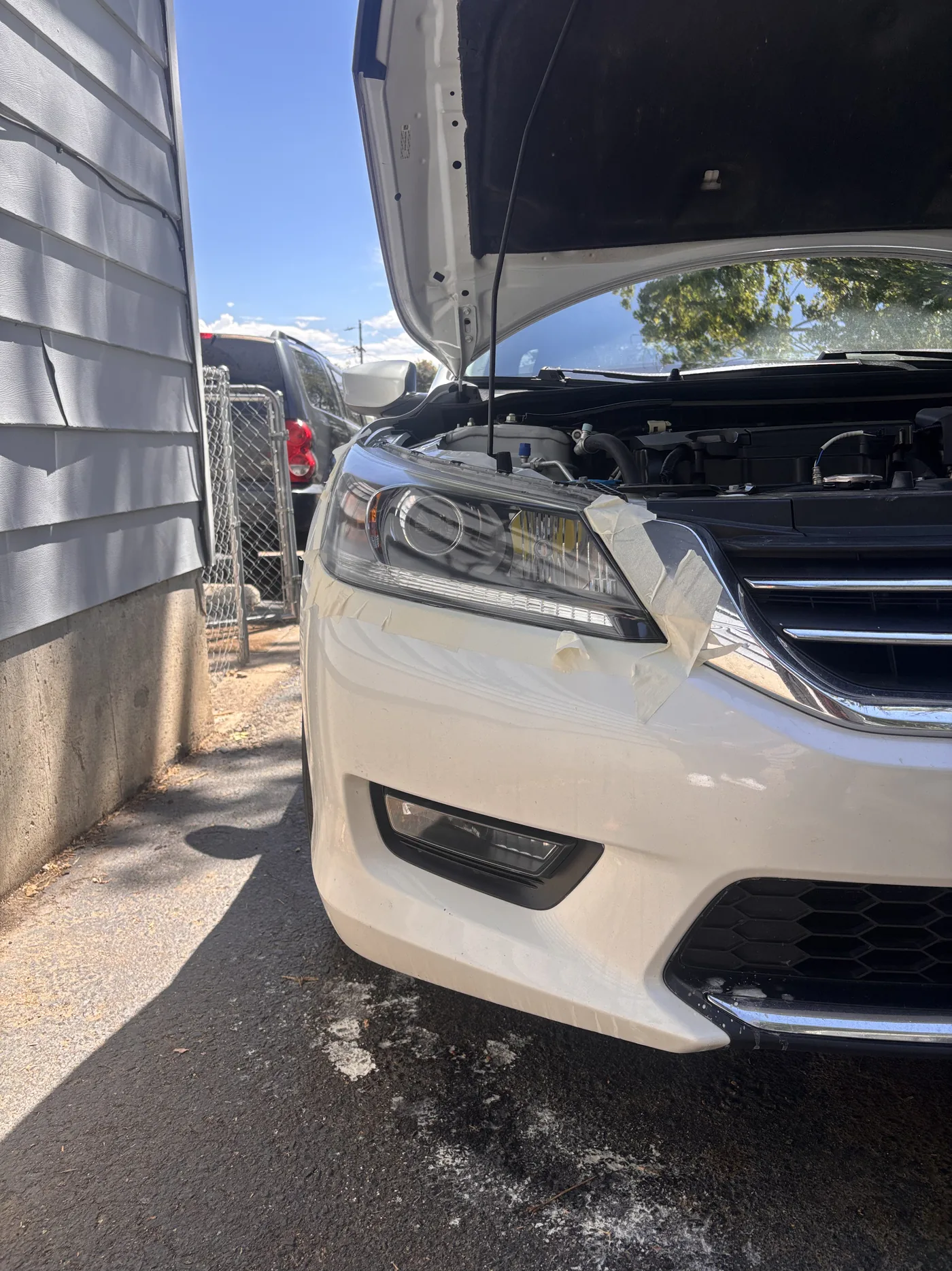 White minivan headlight lens before restoration