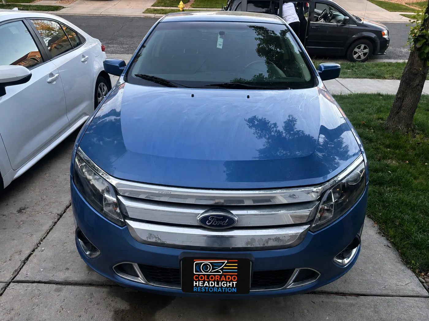 Blue sedan front view showing restored headlights
